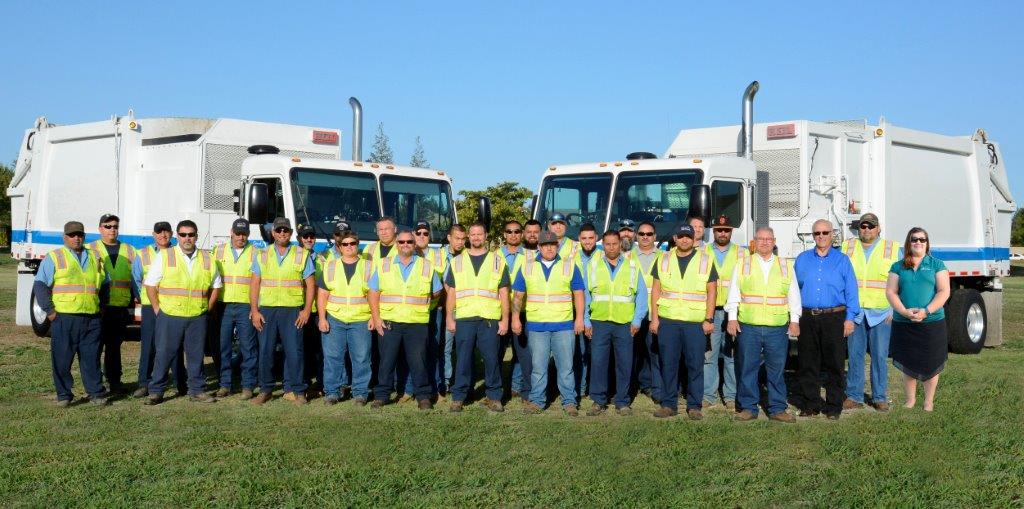 Refuse Division workers in front of trucks